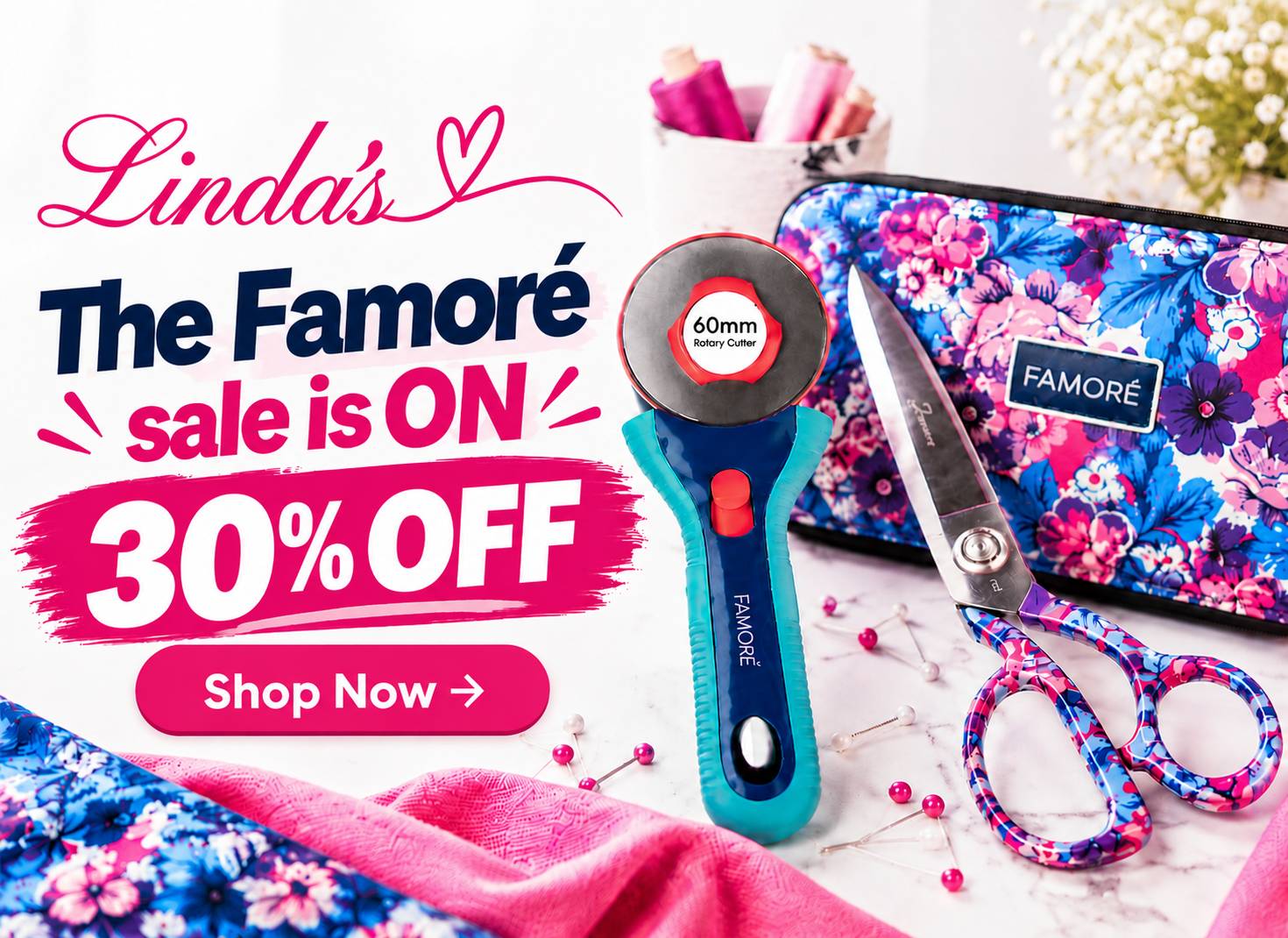 A bright, overhead product flat-lay shows a blue-and-turquoise rotary cutter, floral-patterned scissors and zippered case, folded pink and floral fabr...