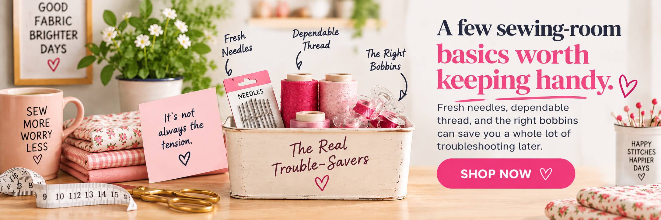 Sewing notions bin holding pink thread spools, a packet of sewing machine needles and clear bobbins — the simple supplies to check before touching the tension dial