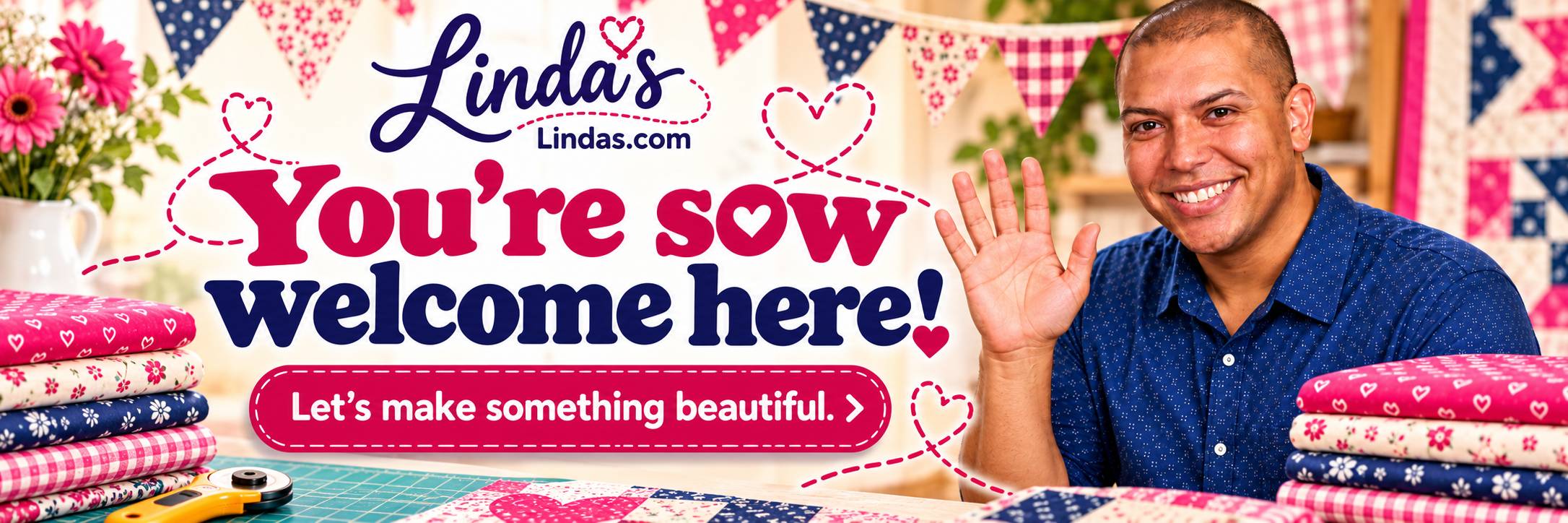 Wide, brightly lit sewing studio banner with a smiling man in a blue patterned shirt raising one hand on the right, beside stacks of colorful folded f...